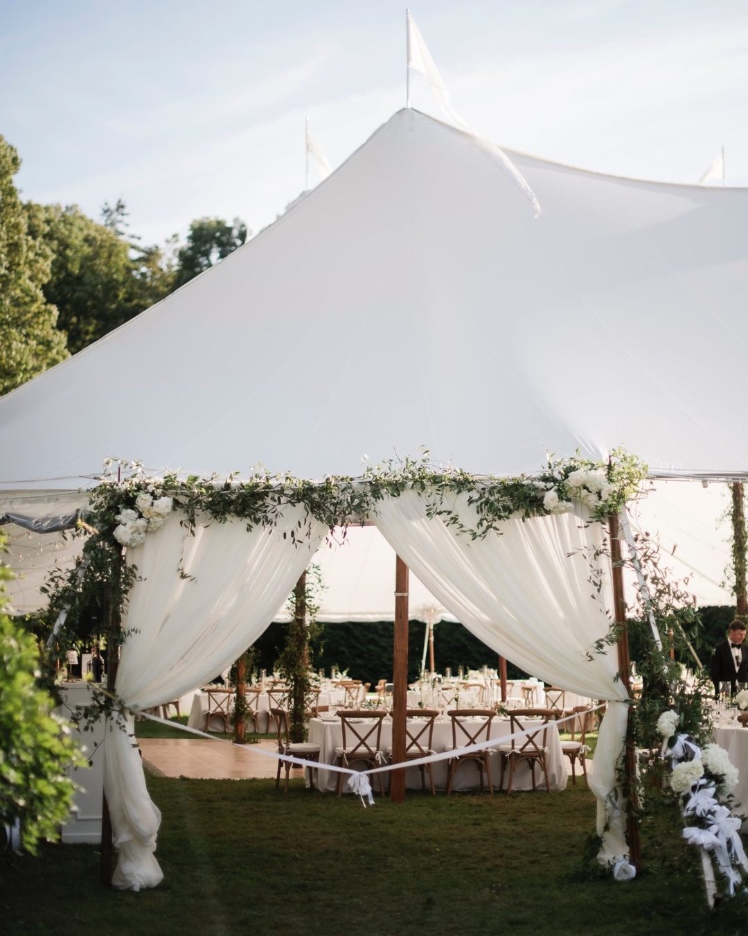 Sailcloth tent reception with draped entry and gathered greenery